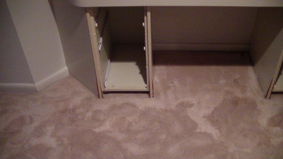 Air movers drying a carpeted floor after water damage