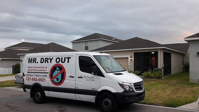 Mr. Dry Out service van at a Tampa Bay home — water extraction and mold remediation since 2004